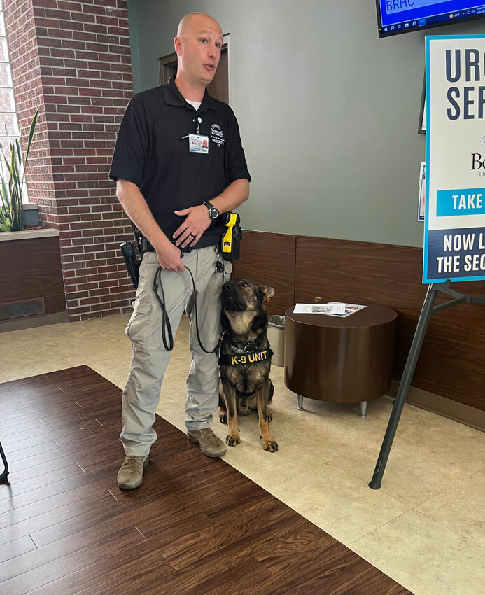 Cutline: Security Officer and K9 Handler Mike VanDeusen regularly provides information about the team&rsquo;s work to outside groups that tour Bothwell Hospital.