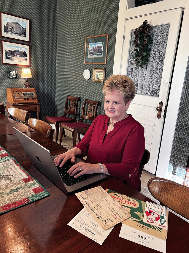 Becky Imhauser works in her downtown office on Wednesday, Nov. 22. She's published a new book this month, &quot;All Around Downtown Sedalia, Missouri Volume 2.&quot;   Photo by Faith Bemiss-McKinney | Democrat