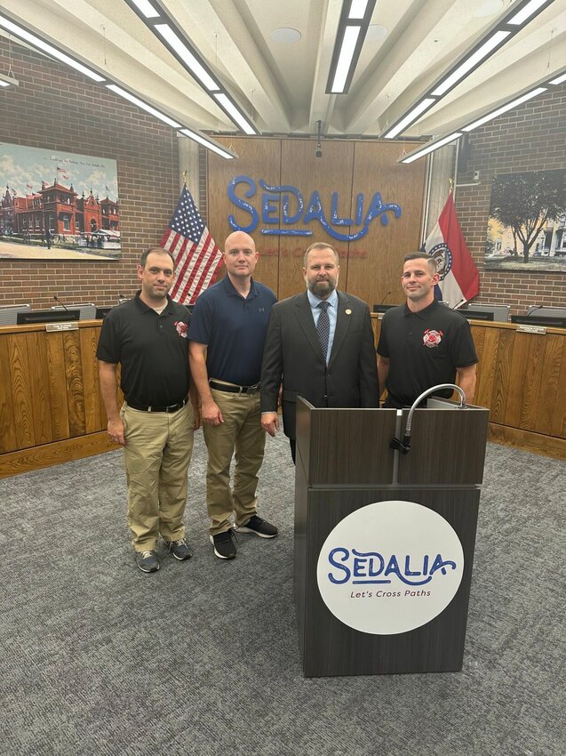 Representatives of the Sedalia Professional Fire Fighters Local 103 pose for a photo with Mayor Andrew Dawson, second from right, after signing a new contract recently.   Photo courtesy of Sedalia Professional Firefighters Local 103