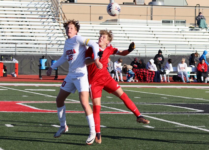 Sacred Heart senior Traven Wheeler (right) vies for a header in Monday's Class 2 district quarterfinal in Odessa. The Gremlins emerged victorious, 4-3, advancing to face Oak Grove in Tuesday's semifinal.   PhotoCredit: Photo courtesy of Sacred Heart Athletics