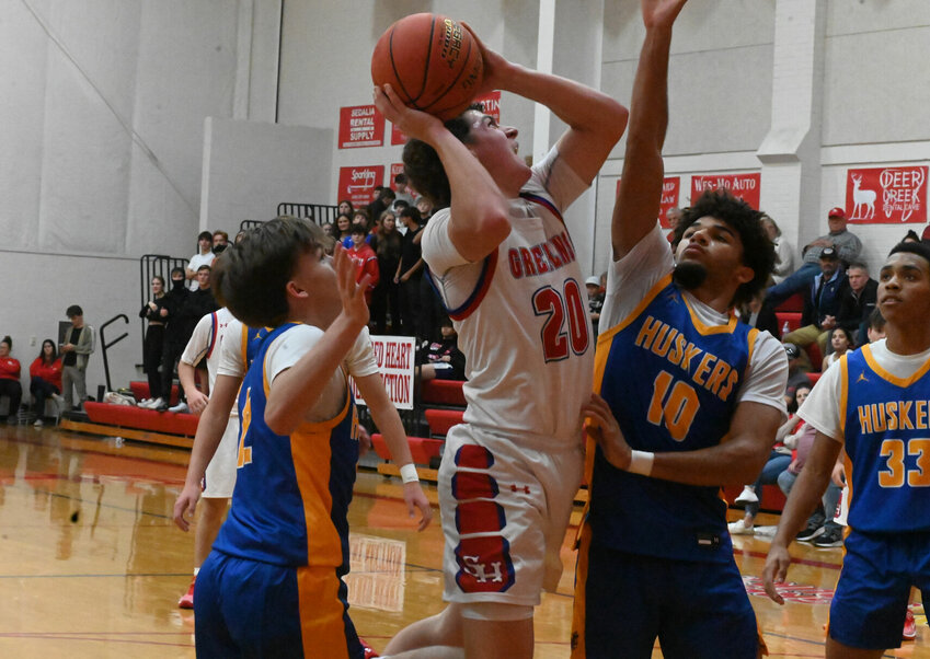 Sacred Heart senior Connor Brown fights for a look at the basket in the paint in Tuesday night's home game against Lafayette County.   PhotoCredit: Photo by Bryan Everson | Democrat
