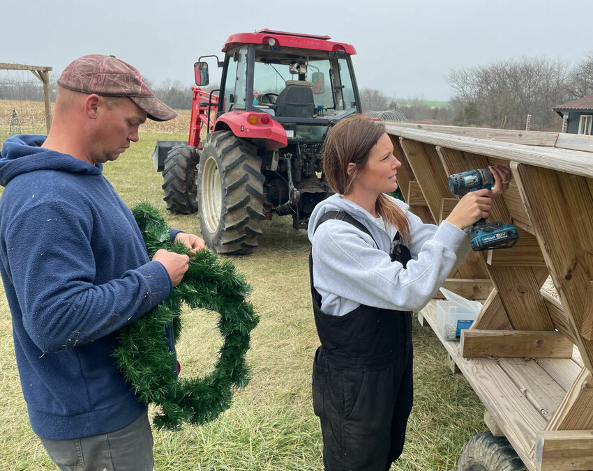 Seen working on Thursday, Nov. 30, Kyle and Allison Rupe will open The Patch by Rupe Family Farms at 6 p.m. Friday, Dec. 1. They will offer hayrides for $8 around the property lit with Christmas lights.   Photo by Chris Howell | Democrat