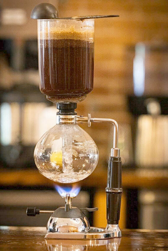 The syphon brewer at Chemistry Coffee Co. in Marshall resembles a chemistry experiment with two glass chambers, a filter, and a butane burner. The shop is owned by Smith-Cotton High School chemistry and physics teacher David Meyer and his wife, Erin.   Photo courtesy of David Meyer