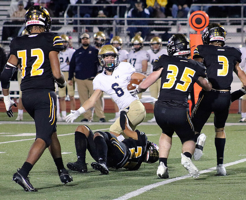 Helias Catholic running back Alex Marberry (8) is surrounded by Smith-Cotton defenders as S-C's Juleis Butner wraps up Marberry's legs in the first quarter of Friday night's CMAC matchup at Tiger Stadium. Closing in are S-C's Rashawn Umbles (72), Sam Wright (35) and Gavin Jackson (3).&nbsp;   PhotoCredit: Photo courtesy of Sedalia School District 200