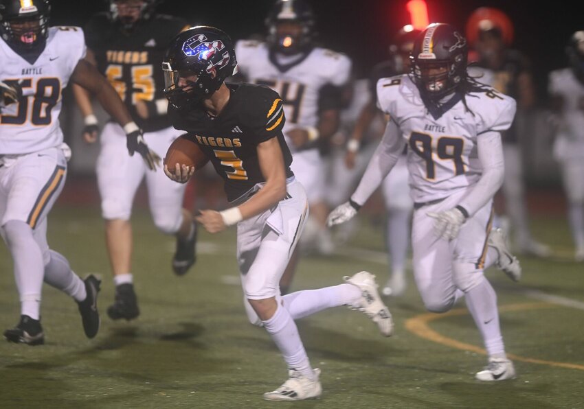 Smith-Cotton's Gavin Jackson attempts to outrun Battle defenders in Friday's 20-14 home defeat. Jackson finished with four receptions for 37 yards.   PhotoCredit: Photo by Bryan Everson | Democrat
