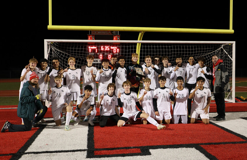 Sacred Heart players and coaches celebrate with the district championship trophy after Thursday night's victory over St. Paul Lutheran in Odessa. The Gremlins await the winner of another district for their Class 2 quarterfinal opponent.&nbsp;   PhotoCredit: Photo courtesy of Sacred Heart Athletics