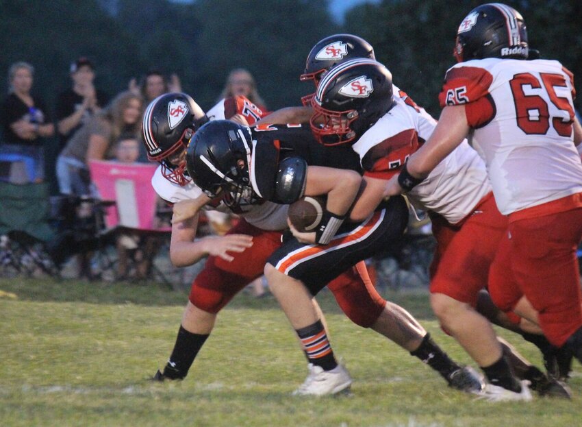Multiple Santa Fe players work to bring down Northwest with Otterville quarterback Dane Palmer in the first half of Friday night's season opener in Hughesville.   PhotoCredit: Photo by Bryan Everson | Democrat
