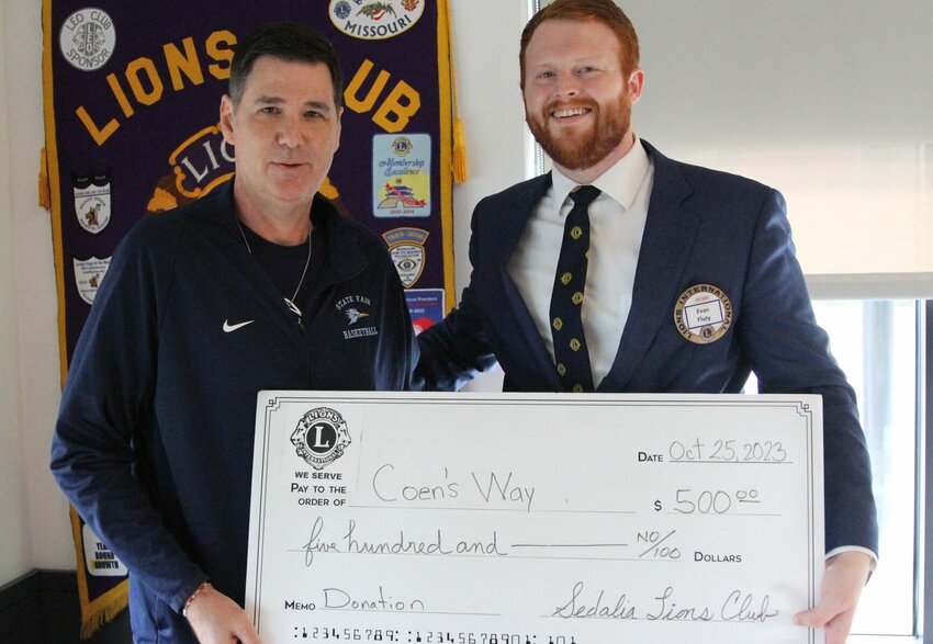 State Fair Community College men's basketball Coach Matt Brown, left, accepts a $500 check from Sedalia Lions Club President Evan Fluty for Coen's Way, a new nonprofit named after Brown's late son. Coen's Way is focused on helping families who have received a cancer diagnosis. For more information, find Coen's Way on Facebook.   Photo courtesy of Sedalia Lions Club