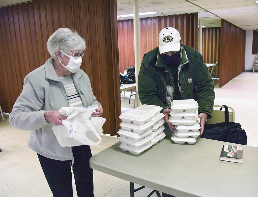 In 2021, volunteers at the Sedalia Warming Shelter box up meals for guests. The shelter is seeking additional volunteers this season as winter approaches.&nbsp;   Fle photo by Faith Bemiss-McKinney | Democrat
