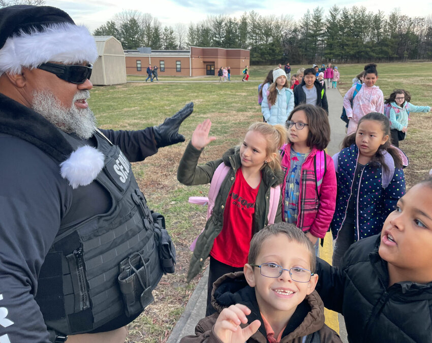 Deputy Larry Parham with the Pettis County Sheriff's Office, with fellow deputies and police officers with the Sedalia Police Department greeted students at Parkview Elementary on &quot;High-five Friday.&quot;   Photo by Chris Howell | Democrat