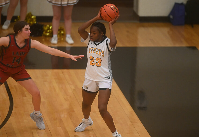 Smith-Cotton's Dominique Bell (10 points) looks for a teammate from the perimeter in Thursday night's home contest against Warrensburg.   PhotoCredit: Photo by Bryan Everson | Democrat