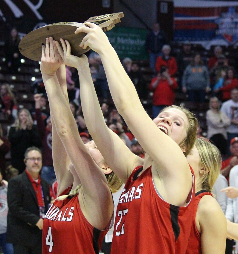 Myra Claas (left) and Briar Cox lift the Class 2 State Championship trophy on March 11, 2023. The Tipton graduates committed to play this upcoming year at State Fair Community College as part of a large incoming recruiting class.   PhotoCredit: File photo by Bryan Everson | Democrat