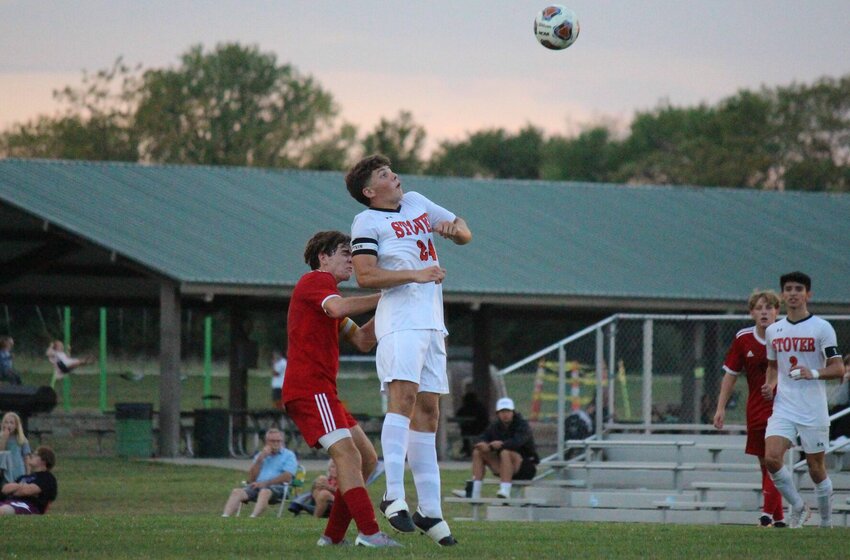 Stover senior Cody Mosher jumps to win a header in a match against Sacred Heart at Clover Dell Park on Sept. 26. The two programs combined to produce nine first-team All-Kaysinger Conference selections.&nbsp;   PhotoCredit: File photo by Bryan Everson | Democrat