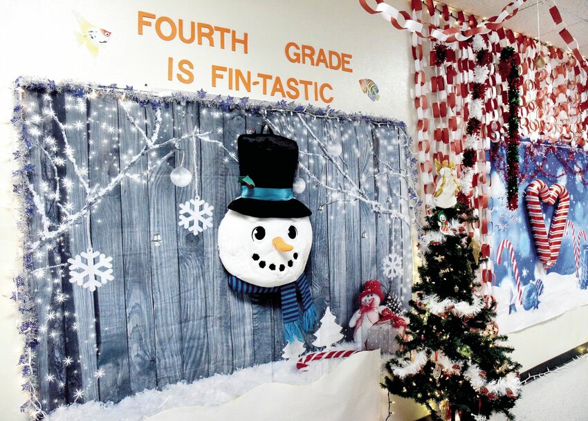 On Monday, Dec. 11, a smiling snowman in the fourth-grade area of Northwest Elementary School in Houstonia sings, &quot;We wish you a Merry Christmas&quot; as one walks by. Northwest staff have decorated the school's hallways for the students for the last five years. Each year, the fun project has grown larger.   Photo by Faith Bemiss-McKinney | Democrat
