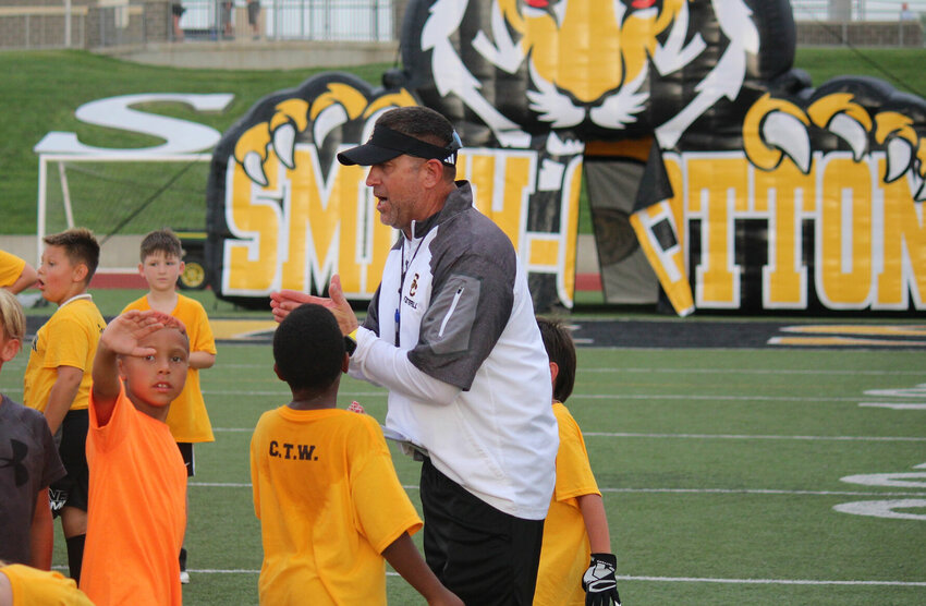 Smith-Cotton football head coach Josh Gray talks to youngsters in black and gold on Tiger Night at the high school on July 27, 2023. S-C football and the remainder of the school's programs will continue to compete in the Central Missouri Activities Conference, at least in the short-term future, as other options continue to be explored.   PhotoCredit: File photo by Bryan Everson | Democrat