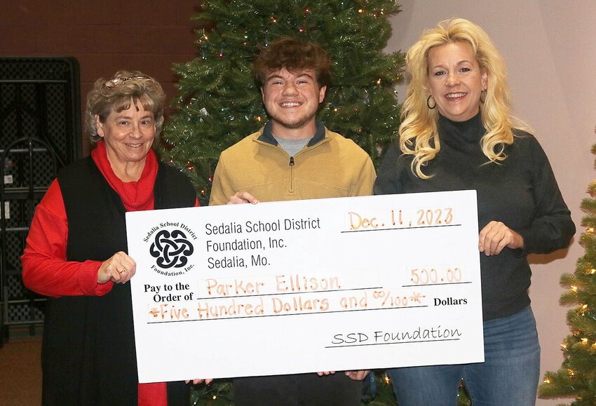 During the Dec. 11 Sedalia School District 200 Board of Education meeting, Smith-Cotton senior Parker Ellison was recognized as this year&rsquo;s recipient of the district-level John T. Belcher Scholarship. With Ellison are School Board President Diana Nichols, left, and Sedalia School District Foundation President Diedre Esquivel. The Foundation provides the $500 local scholarship.   Photo courtesy of Sedalia School District 200