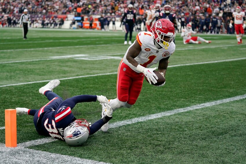 Kansas City Chiefs running back Jerick McKinnon (1) enters the end zone for a touchdown as New England Patriots linebacker Marte Mapu (30) tries to defend during the first half of an NFL football game, Sunday, Dec. 17, 2023, in Foxborough, Mass.   PhotoCredit: Photo by Charles Krupa | AP Photo