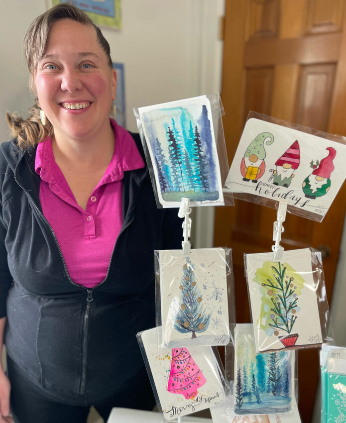 Lindsey Starr, owner of Artistic Isle, 120 E. Sixth St., seen Wednesday, Dec. 20 with her hand-painted Christmas cards, is one of three local businesses inviting vendors Saturday, Dec. 23 for a last-minute vendor fair. The Chubby Hair Stylist, 312 S. Ohio Ave., and Silver Fang Crystals, 309 S. Ohio Ave., are also participating in the event.   Photo by Chris Howell | Democrat