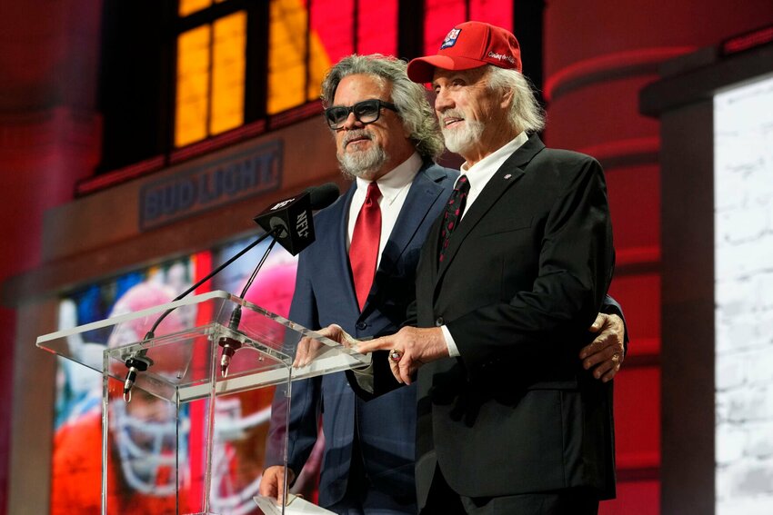 Ed Budde, right, and Brad Budde announce the No. 55 pick for the Kansas City Chiefs at the NFL football draft April 28, 2023, in Kansas City, Mo. The Chiefs picked SMU wide receiver Rashee Rice. Ed Budde, who spent 14 years playing along the offensive line of the Chiefs and helped the franchise win its first Super Bowl with a victory over Minnesota in 1970, died Tuesday, Dec. 19, 2023. He was 83. The family announced his death through a statement issued by the Chiefs. No cause of death was provided.   PhotoCredit: File photo by Steve Luciano | AP Photo
