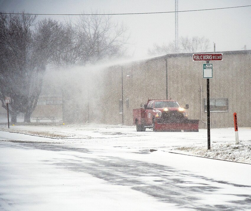 On East Third Street, at the Sedalia Public Work Barn, a city snow plow waits as blowing snow wafts off the roof Thursday, Dec. 22, 2022. While Sedalia has experienced mild temperatures and little precipitation this December, Sedalia received about 1 inch of snow during the pictured 2022 snowfall, according to the National Weather Service, along with temperatures as low as -7.   File photo by Faith Bemiss-McKinney | Democrat