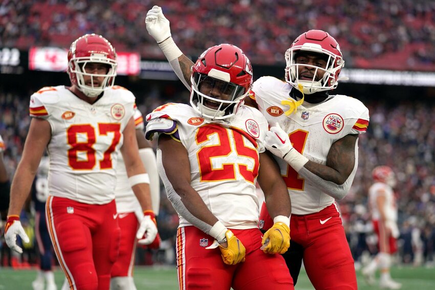 Kansas City Chiefs running back Clyde Edwards-Helaire (25) celebrates after his touchdown with tight end Travis Kelce (87) and running back Jerick McKinnon (1) during the second half of an NFL football game against the New England Patriots, Sunday, Dec. 17, 2023, in Foxborough, Mass.   PhotoCredit: Photo by Charles Krupa | AP Photo