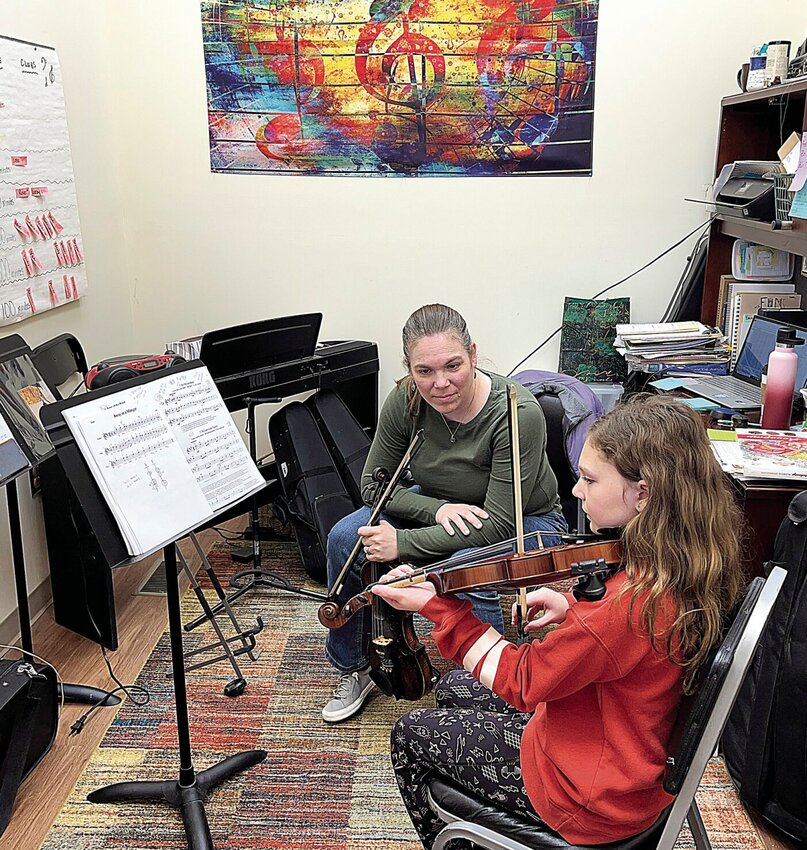On Thursday, Dec. 21, Liz Kehl, owner of Sedalia Strings Academy LLC in downtown Sedalia, gives a violin lesson to Preslee Moon, a fourth grader at Sacred Heart School. Moon played &quot;Away in a Manger&quot; for the Sunday afternoon Christmas Eve Mass at St. Vincent de Paul Parish St. Patrick Church.   Photo by Faith Bemiss-McKinney | Democrat