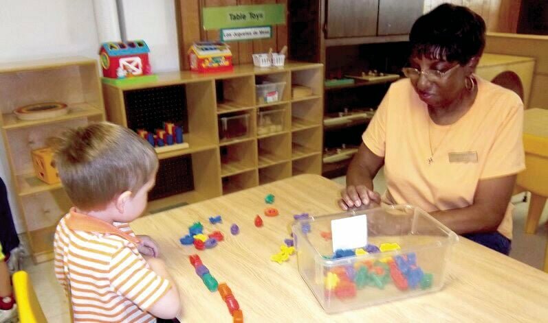 A volunteer with the AmeriCorps Seniors Foster Grandparent Program helps a child with math. The local program based in Marshall is looking for volunteers in the Sedalia area.   Photo courtesy of AmeriCorps Seniors Foster Grandparent Program