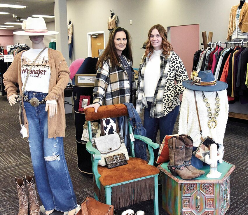 Wednesday morning, Dec. 27, Marie Dennis, owner of Ivy's Closet, and her daughter, Kaytlin VanSteenburgh, stand in the shop located in State Fair Shopping Center. The shop sells high-end and designer clothing on consignment and has 118 consignees.   Photo by Faith Bemiss-McKinney | Democrat