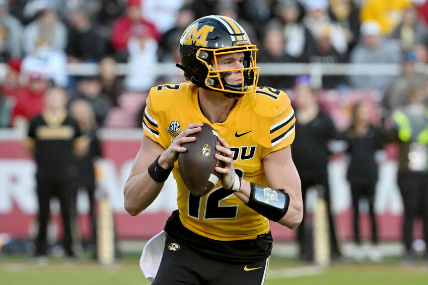 Missouri quarterback Brady Cook (12) against Arkansas during an NCAA college football game Friday, Nov. 24, 2023, in Fayetteville, Ark. Ninth-ranked Missouri is in its first New Year&rsquo;s Six game during the four-team College Football Playoff era against seventh-ranked Ohio State in the Cotton Bowl.   PhotoCredit: File photo by Michael Woods | AP Photo
