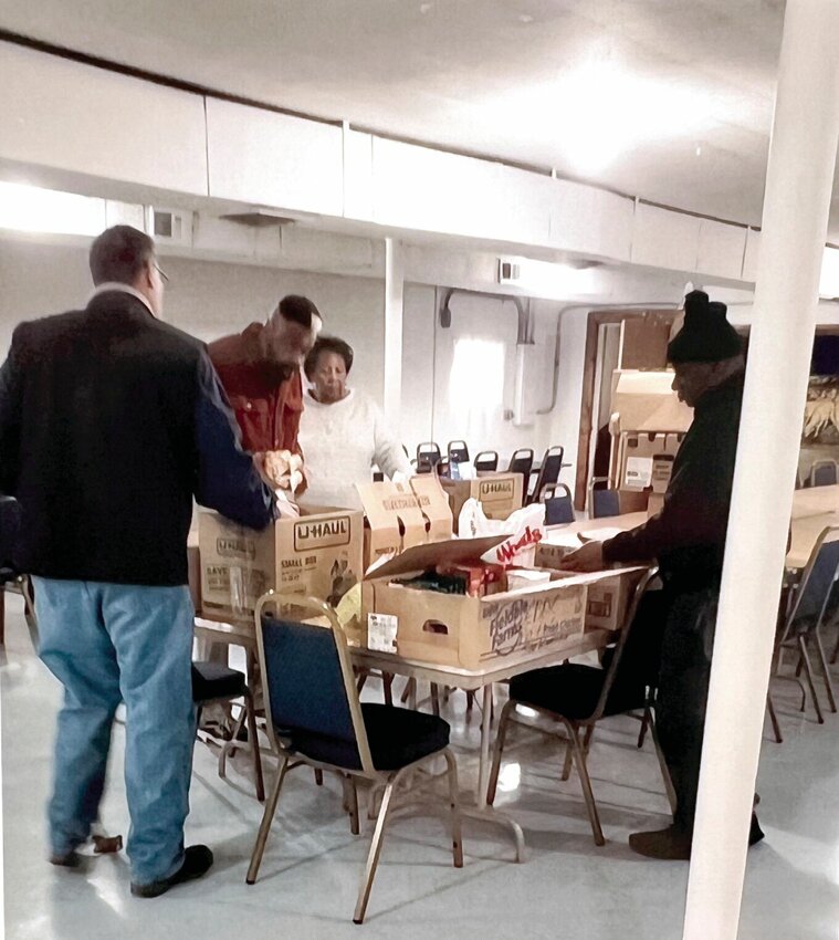 Members of the Sedalia/Pettis County Chapter of the NAACP package Christmas baskets for four families in the community that were delivered Wednesday, Dec. 20.   Photo courtesy of the Sedalia/Pettis County Chapter of the NAACP