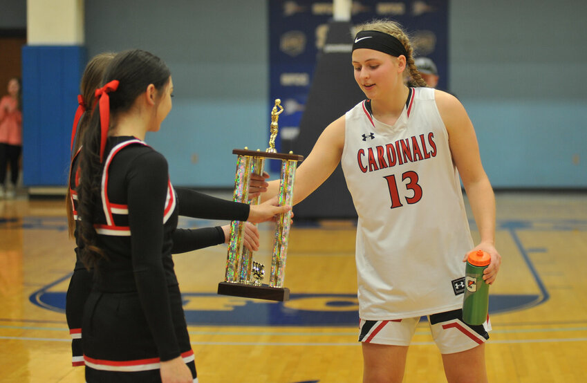 Tipton's Kenna Bixler accepts the Kaysinger Conference Girls Basketball Tournament Championship trophy on Feb. 5, 2022. The Cardinals' departure from the conference opened up the door for recent discussion of expansion.   PhotoCredit: File photo by Bryan Everson | Democrat
