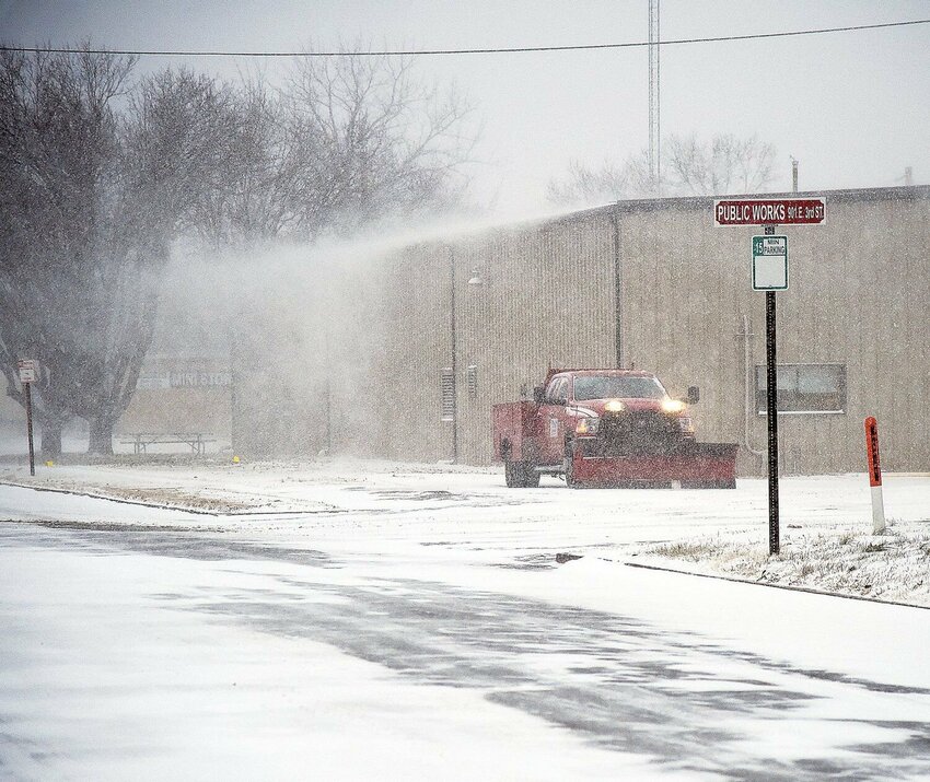 On East Third Street, at the Sedalia Public Work Barn, a city snow plow waits as blowing snow wafts off the roof Thursday, Dec. 22, 2022. The first snowstorm of 2024 hit Pettis County on Monday, Jan. 8 and is expected to continue through Tuesday, Jan. 9, with a chance for snow again later this week.   File photo by Faith Bemiss-McKinney | Democrat