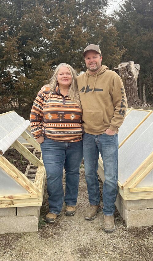 David and Brandy Von Holten, owners of Von Holten Ranch in Mora, stand beside greenhouse covers David created for a new program they are introducing this year, Country Tough Homesteading.   Photo courtesy of Jed Baton