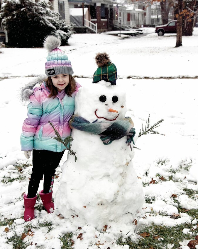 On Tuesday, Jan. 9, with schools closed due to the overnight snowfall, Addie Kehoe, 8, got up early to make a snowman with her grandfather, Dave Kehoe, on Dal Whi Mo Court. The pair had completed the snowman by 9 a.m. Additional snowfall is expected on Friday, Jan. 12, with temperatures plummeting to single digits. The extreme weather has prompted the opening of the Sedalia Warming Shelter in the basement of St. Vincent de Paul Parish St. Patrick Church.   Photo by Faith Bemiss-McKinney | Democrat