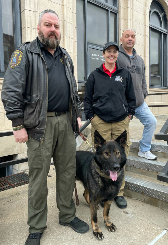 From left, Sgt. Nichols will be bringing new K9 Diesel to work at the Pettis County Jail, a chocolate lab named Jimmy will soon work with School Resource Officer Deputy Stephanie Bahner at Smithton High School, and a German wire-haired pointer named Albert will accompany SRO Deputy Neil Trout at La Monte High School.   Photo by Chris Howell | Democrat