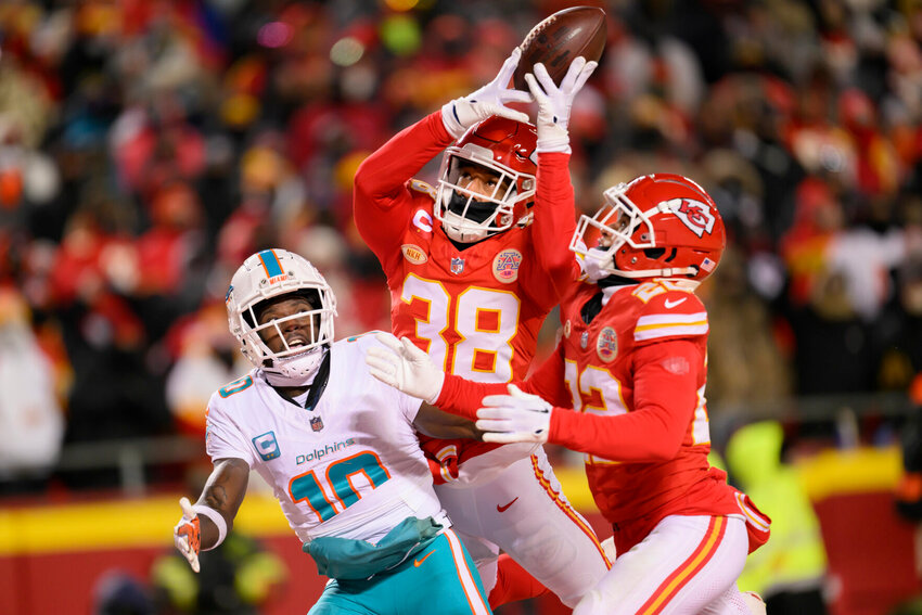 Kansas City Chiefs cornerback L'Jarius Sneed, center, nearly intercepts a pass intended for Miami Dolphins wide receiver Tyreek Hill (10) with Chiefs cornerback Trent McDuffie (22) helping during the second half of an NFL wild-card playoff football game, Saturday, Jan. 13, 2024 in Kansas City, Mo.   PhotoCredit: Photo by Reed Hoffmann | AP Photo