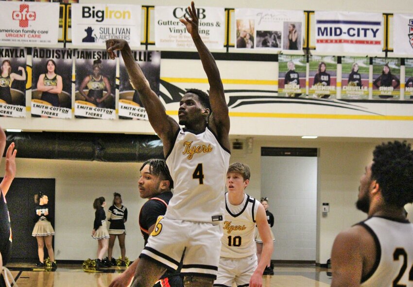 Smith-Cotton senior Jayshawn Bennett releases a mid-range jumper in Tuesday night's victory over Knob Noster, the Tigers' first victory of the season. Bennett ended with a game-high 16 points.&nbsp;   PhotoCredit: Photo by Bryan Everson | Democrat