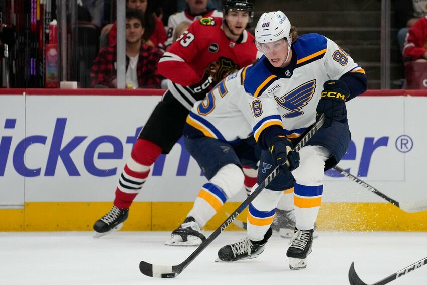 St. Louis Blues right wing Adam Gaudette passes the puck during the first period of the team's preseason NHL hockey game against the Chicago Blackhawks Thursday, Sept. 28, 2023, in Chicago. Gaudette is back in the NHL after spending more than a year and a half in the minors. Gaudette on Thursday night is set to play his first game in the league since April 2022, suiting up for the St. Louis Blues at the Washington Capitals.   PhotoCredit: File photo by Erin Hooley | AP Photo