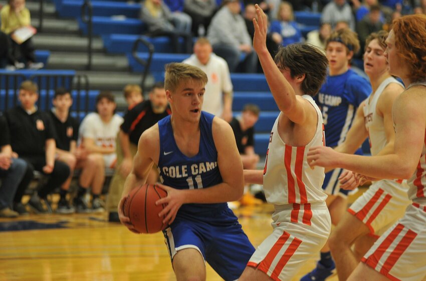 Cole Camp's Ethan Corpening protects the ball from Northwest defenders in a Kaysinger Conference Tournament quarterfinal game on Jan. 29, 2022. The Bluebirds come into this year's boys tourney as the No. 1 seed.   PhotoCredit: File photo by Bryan Everson | Democrat