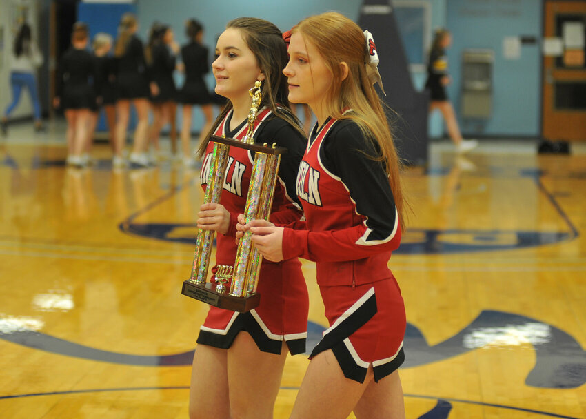 A pair of Lincoln cheerleaders present the Kaysinger Conference Boys Tournament first-place trophy to the Cardinals after winning the 2022 edition on Feb. 5, 2022. The Cards are part of a deep field this year that's led by the top-seeded Cole Camp Bluebirds.&nbsp;   PhotoCredit: File photo by Bryan Everson | Democrat