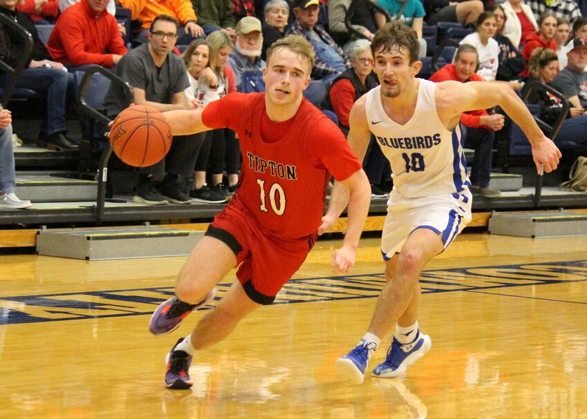 Tipton's Jackson Bailey is trailed by Cole Camp guard Reid Harrison in Tuesday evening's Kaysinger Conference Boys Tournament semifinal. The Cardinals won to advance to the title game against Sacred Heart.   PhotoCredit: Photo by Bryan Everson | Democrat