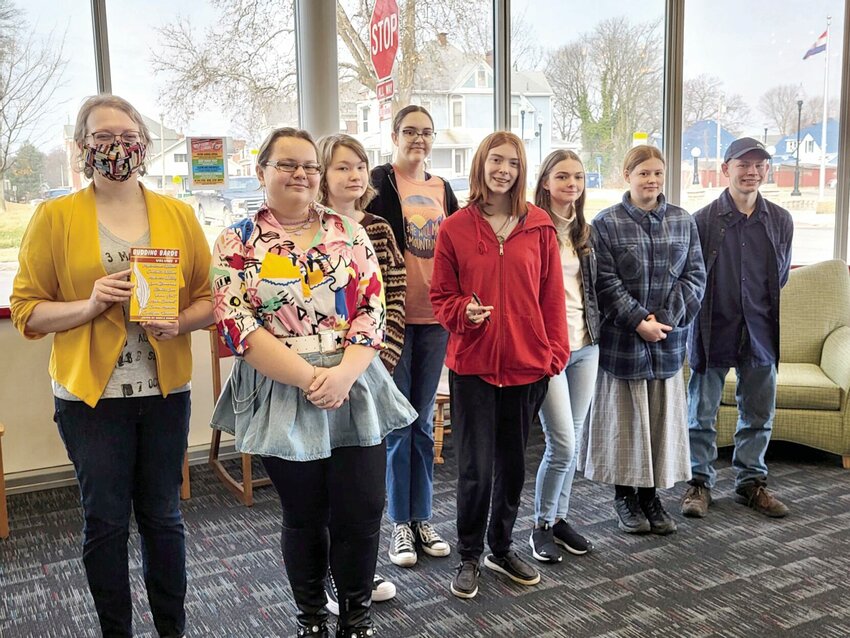 On Saturday, Feb. 3, from left, local author Angela Roquet stands with Boonslick Regional Library's Budding Bards Maria Sheremet, Elizabeth Lauer, Serena Mahnken, Venom Holt, Laura Zimmerman, Makenzie Whiting and Christopher Redwood   Photo courtesy of Boonslick Regional Library