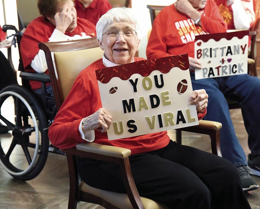 Primrose Retirement resident Bonnie Morris holds up a sign on Thursday, Feb. 8 as 30 residents prepare to create another Kansas City Chiefs video for Super Bowl LVIII. The group, known as the Primrose Chiefs Cheerleaders, had their first video go viral and were in the news across the country.   Photo by Faith Bemiss-McKinney | Democrat