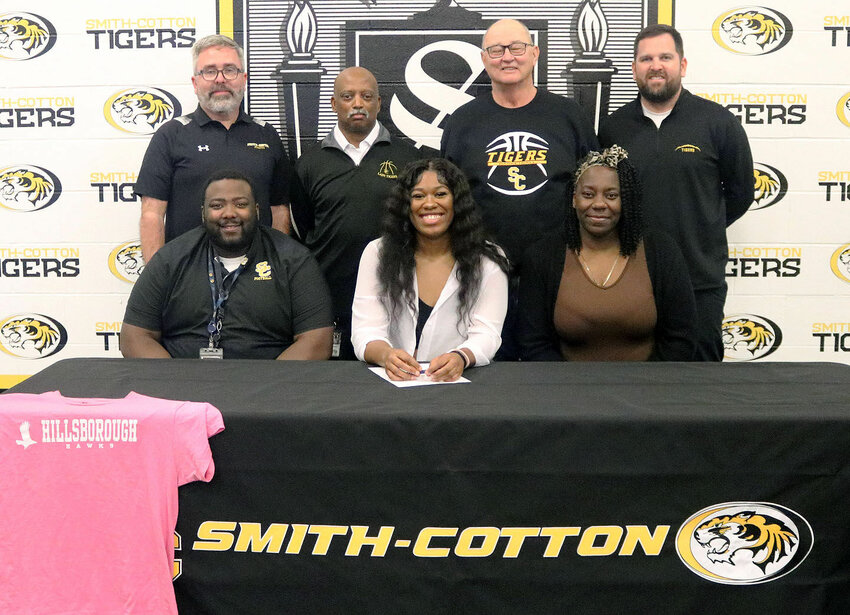 Anastasia Bellamy, a Smith-Cotton High School senior, has accepted a scholarship to play basketball at Hillsborough Community College in Plant City, Fla. Seated with her at the table are her brother, Terrence Callaway, and her mother, Sarah Bellamy; back row, from left: S-C Principal Wade Norton, S-C Girls Basketball Assistant Coach Lance Williams, S-C Girls Basketball Head Coach Ron Rhodes, and S-C Activities Director Kyle Middleton.   PhotoCredit: Photo courtesy of Sedalia School District 200&nbsp;