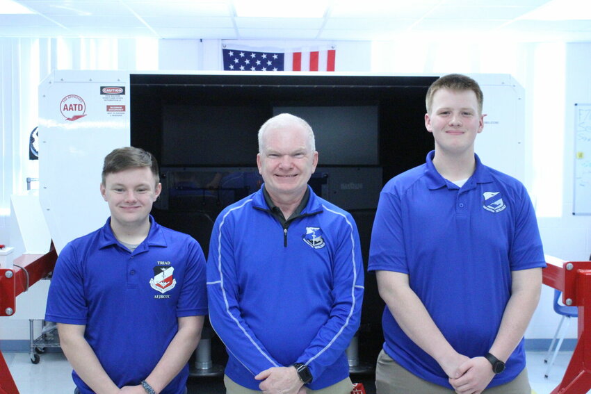 From left, Cadet Corps group commander Logan Hutchens, Senior Aerospace Science Instructor and coach Mark Talley, and CyberPatriot program coordinator Nathan Wiltrout pose for a photo in front of a flight simulator on Friday, Feb. 9, at Knob Noster High School. 


Photo by Zach Bott | Warrensburg Star-Journal