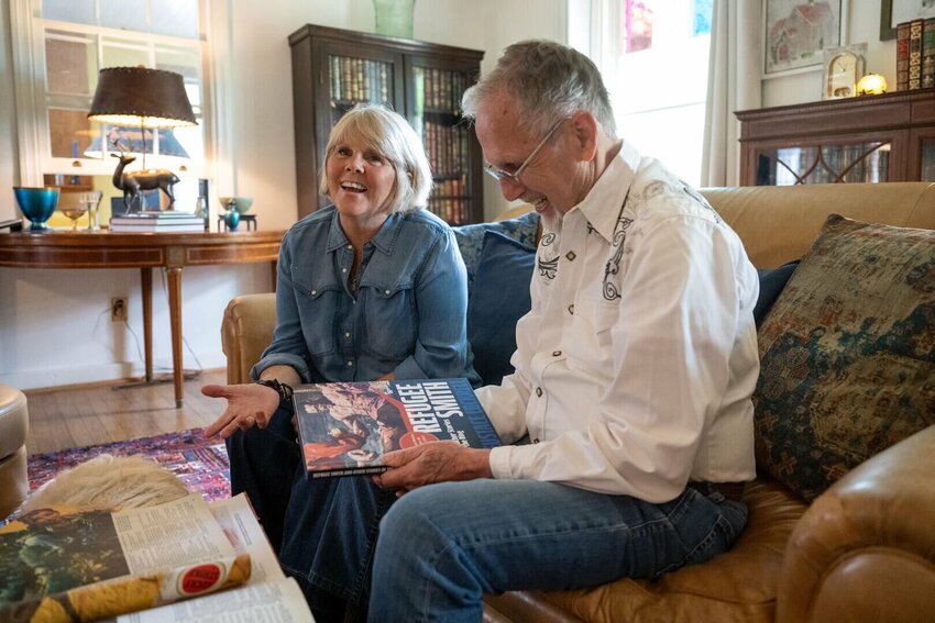 Roger Coleman, right, holds a copy of &quot;Refugee Smith and Other Stories of the Ring, Collected Works, Volume III,&quot; while sitting next to his wife, Elizabeth. Coleman has spent the last 25 years collecting Eustace Cockrell's stories.&nbsp;   Photo courtesy of Roger Coleman
