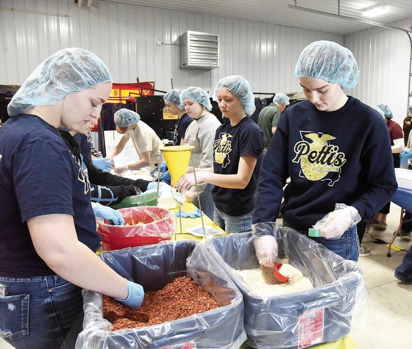 On Tuesday, Feb. 20, Shelby Dotson, on left, and Karli Smith, on the right, both seniors and FFA members at Pettis County R-V Northwest High School in Hughesville, help pack meals for food insecure students in the county. FFA students from Hughesville, La Monte, Green Ridge, and Smithton helped pack 15,000 meals during the second annual event.


Photo by Faith Bemiss-McKinney | Democrat