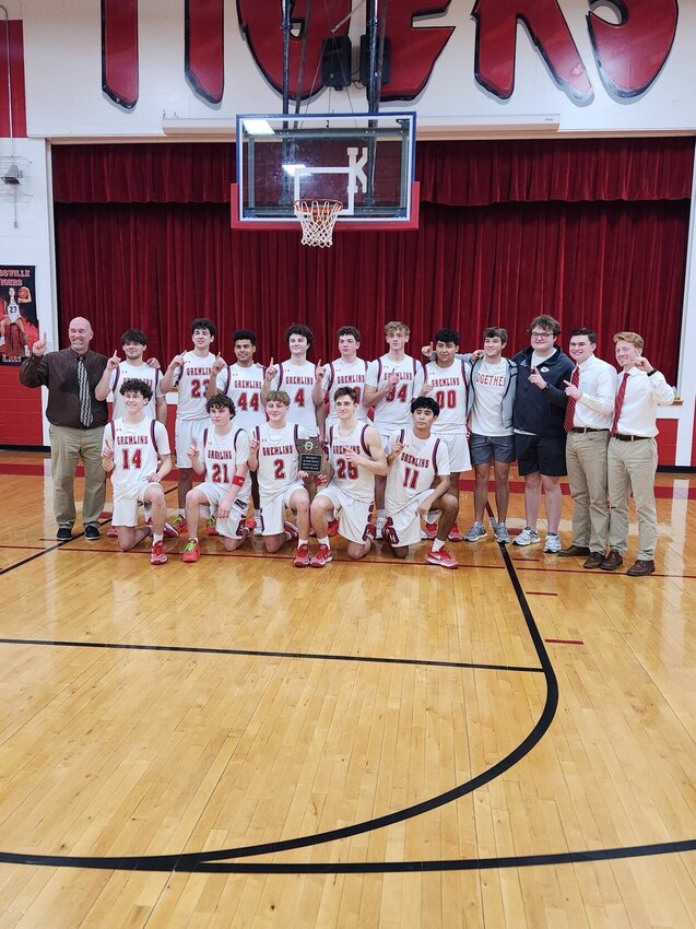 The Sacred Heart boys basketball team celebrates its district title Saturday after defeating Pilot Grove 60-49. Photo courtsey of Payton Sheer