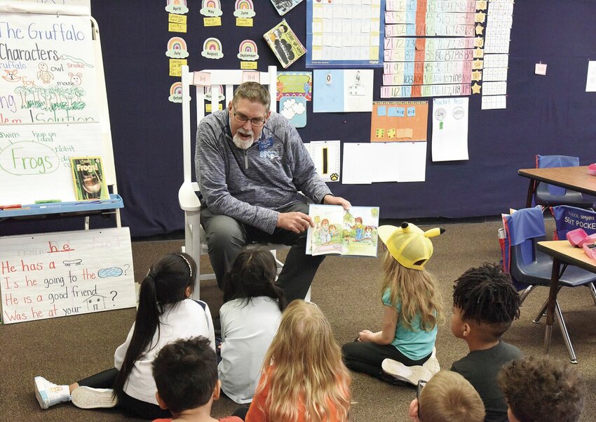 Brent Bates, a Sedalia Rotary Club member and president of State Fair Community College, reads to Dani Gerke's kindergarten class at Horace Mann Elementary School on Monday, March 4. Bates read &quot;Just Like Dad&quot; for the annual Rotary Reads Program.   Photo by Faith Bemiss-McKinney | Democrat