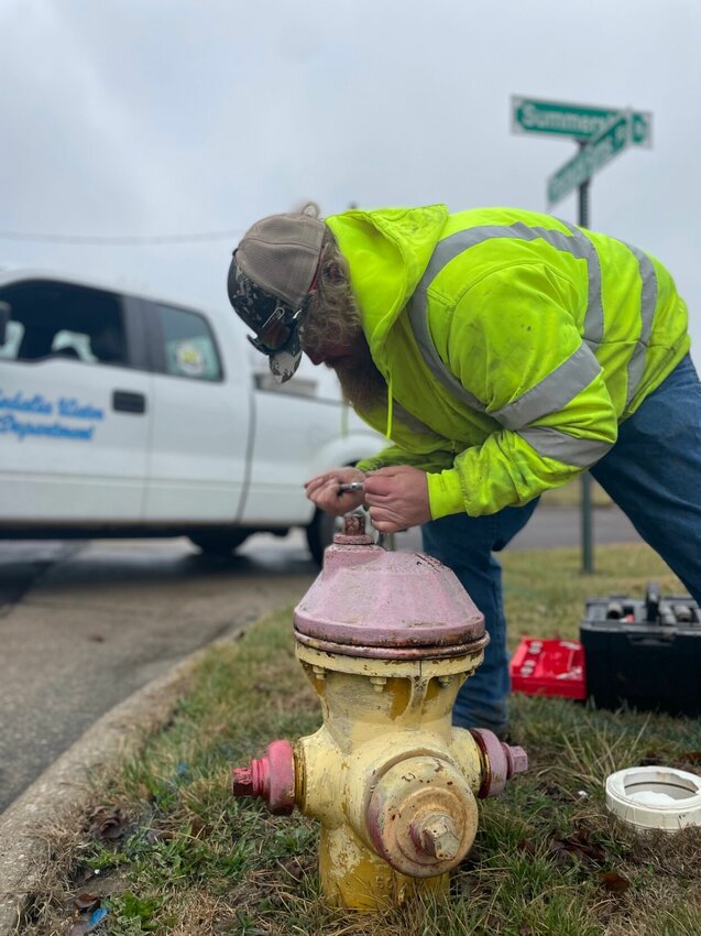 Sedalia Water Department crew foreman Aaron Shewmaker repairs a faulty fire hydrant Friday on Prestwick Farms Road on Friday, March 8.   Photo by Chris Howell | Sedalia Democrat